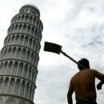 Chinese worker walks past a replica of the leaning Tower of Pisa in Shanghai.