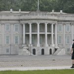 Visitor takes photographs of a replica of the White House at Beijing World Park